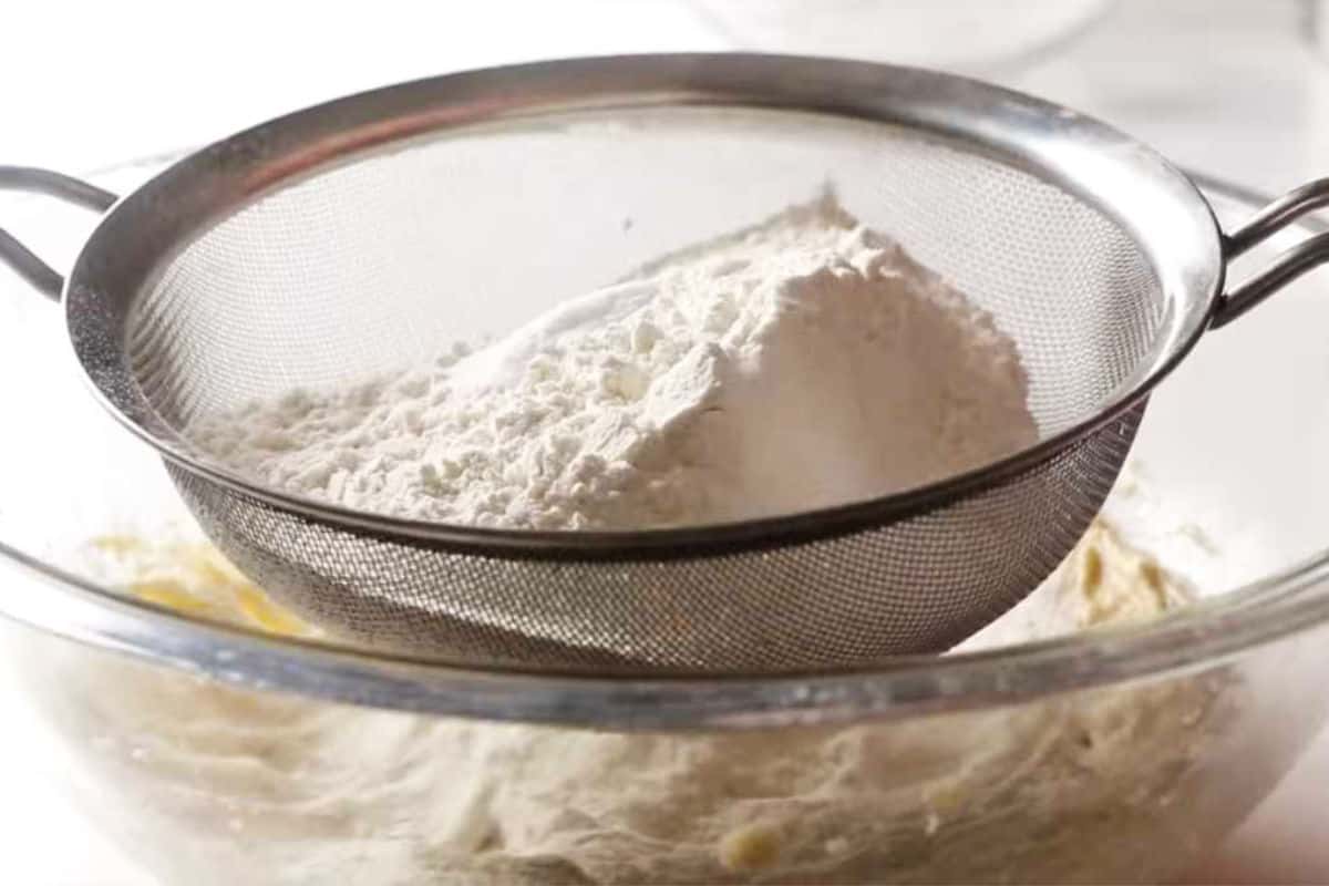 Sifting flour for cake batter.
