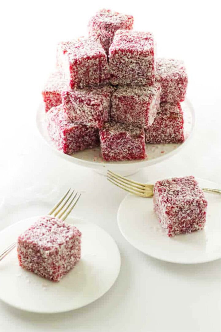 cake stand with a stack of raspberry lamingtons.