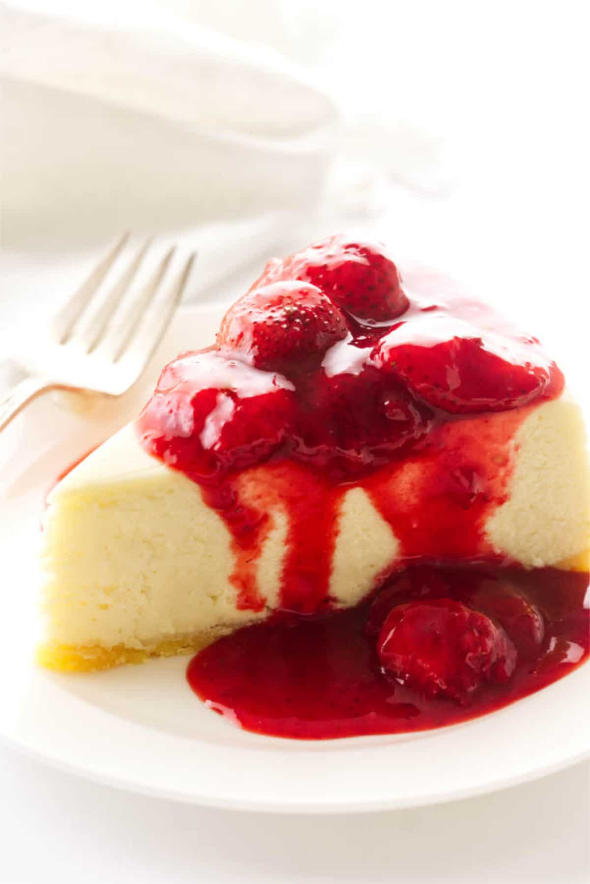no water bath cheesecake with strawberry sauce on top.